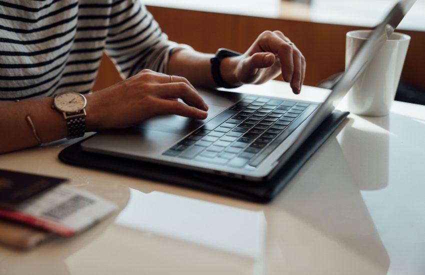hands on a laptop