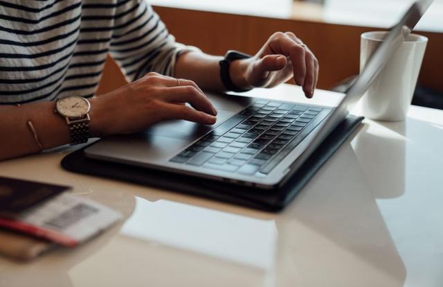 hands on a laptop