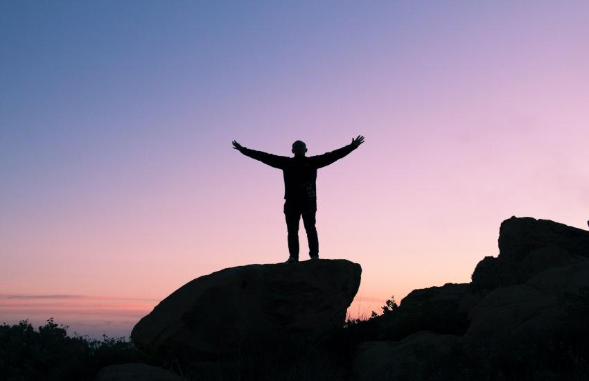 person on top of a big rock