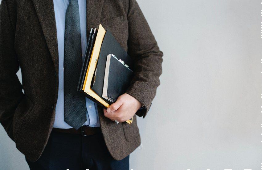 man carrying a portfolio and notebook