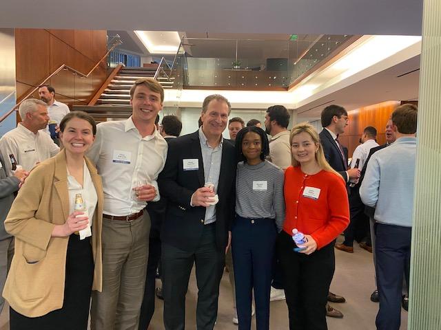 employees posing for a group shot at a networking event