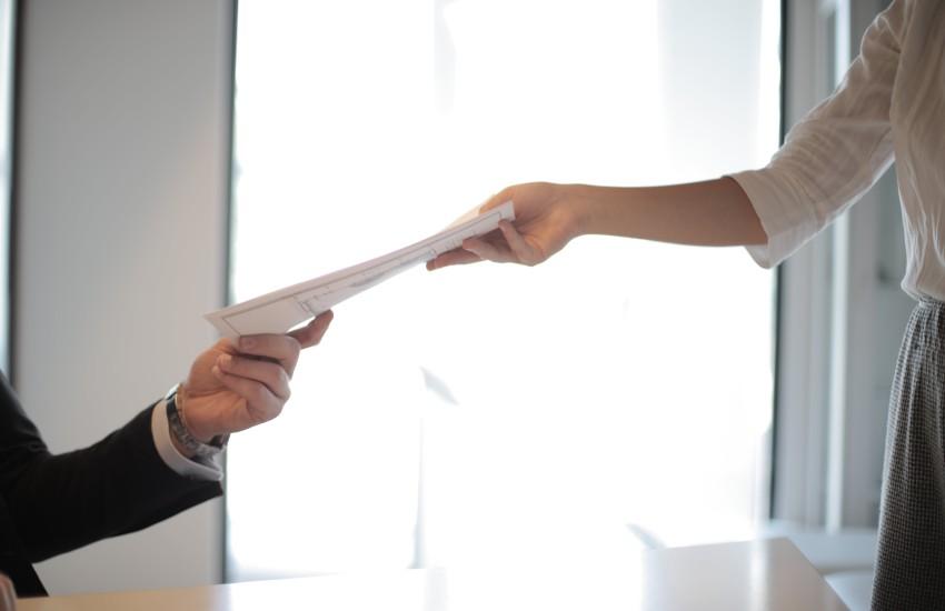 people exchanging papers