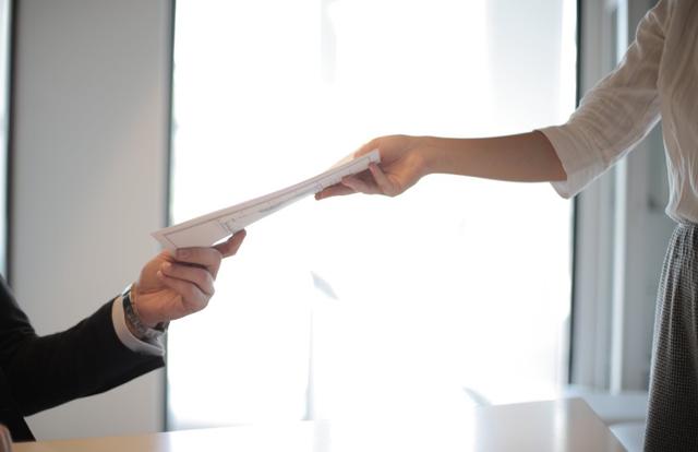 people exchanging papers