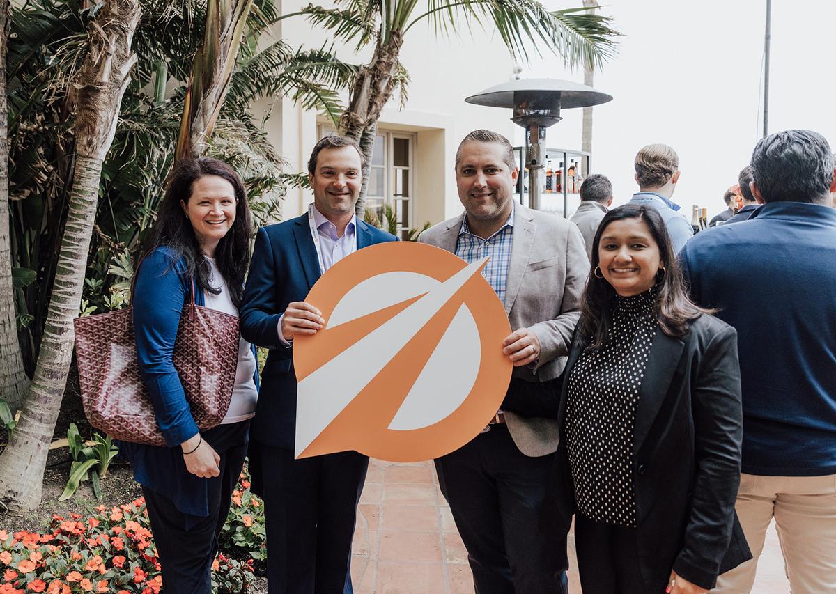 Group of people holding a cutout of the cohnreznick logo