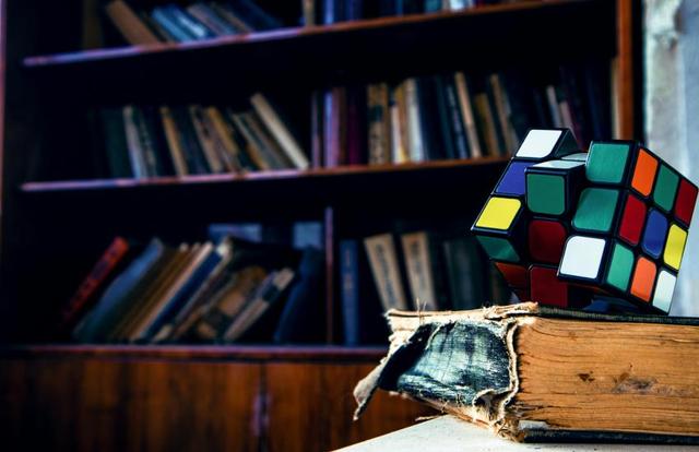 rubiks cube on a tattered book